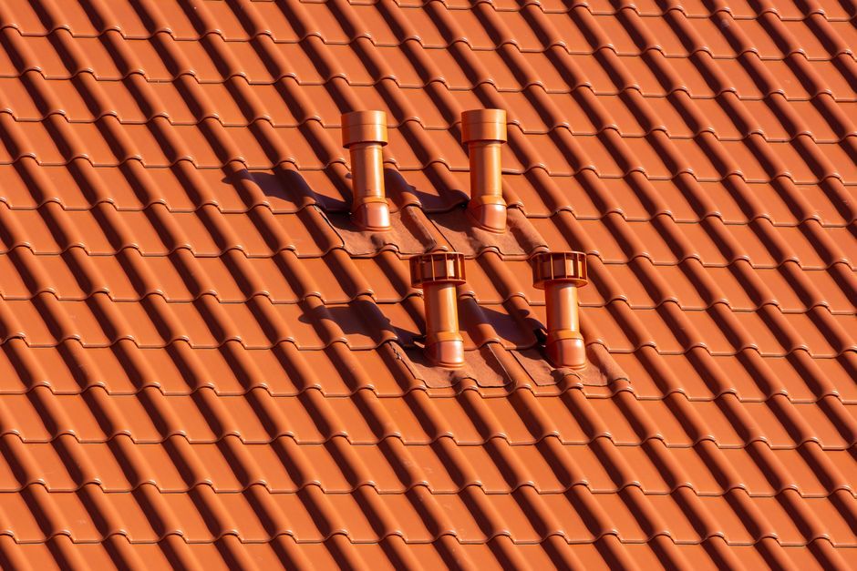 Sorties de conduits traversant une couverture en tuiles